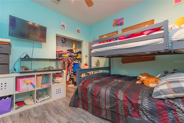 313 Jefferson Ave S, Oldsmar, FL 34677 - bedroom with a walk in closet, a closet, wood finished floors, and a ceiling fan