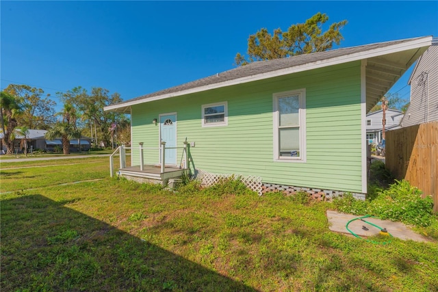 313 Jefferson Ave S, Oldsmar, FL 34677 - rear view of house with a lawn and fence