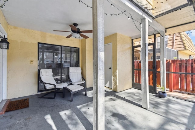 view of patio featuring fence and a ceiling fan