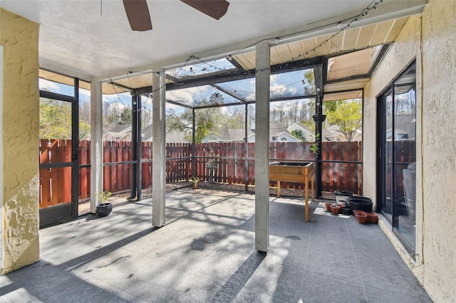 sunroom featuring a ceiling fan