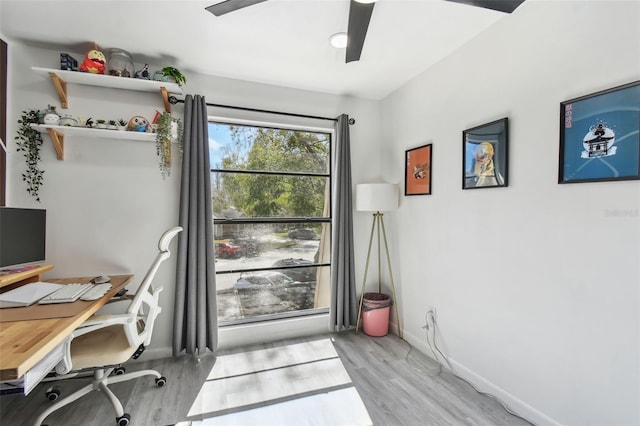 office area with ceiling fan, baseboards, and wood finished floors