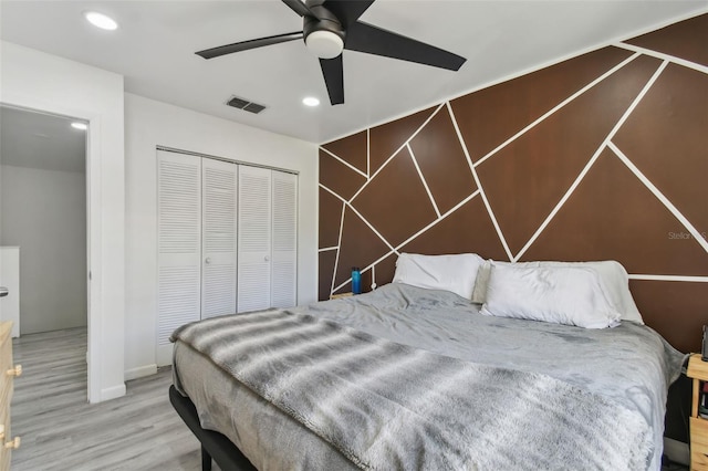 bedroom featuring recessed lighting, a closet, visible vents, and wood finished floors