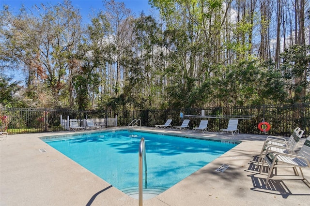 pool featuring a patio area and fence