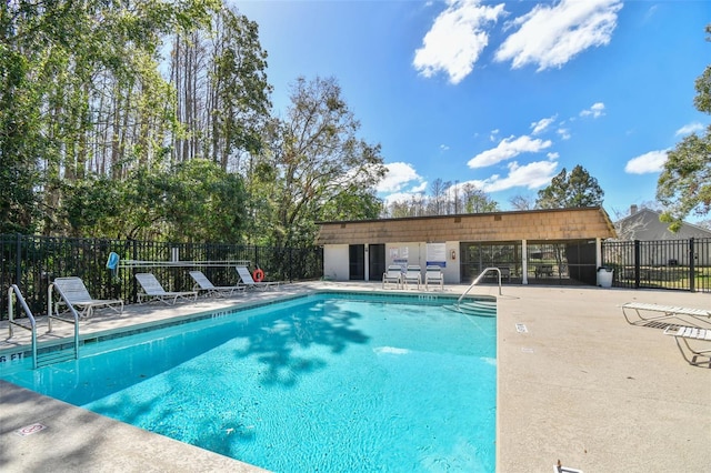 community pool featuring a patio area and fence