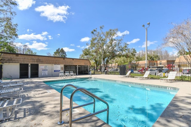 pool featuring a patio area and fence