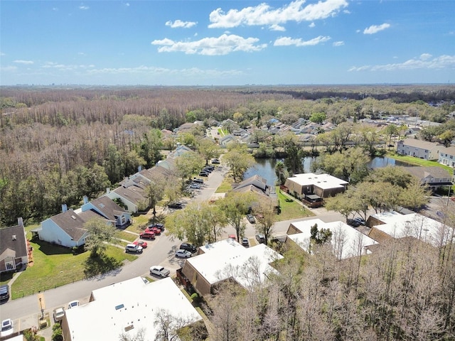 drone / aerial view featuring a residential view and a view of trees