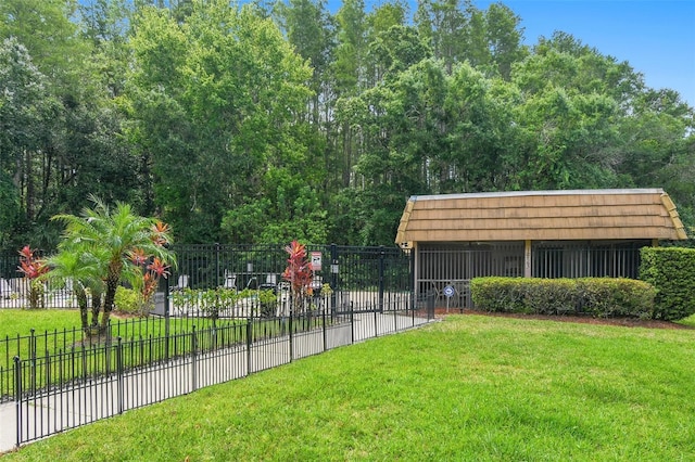 view of home's community with a lawn and fence