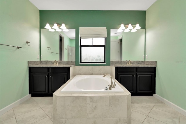 full bath featuring a garden tub, two vanities, a sink, a walk in shower, and tile patterned flooring