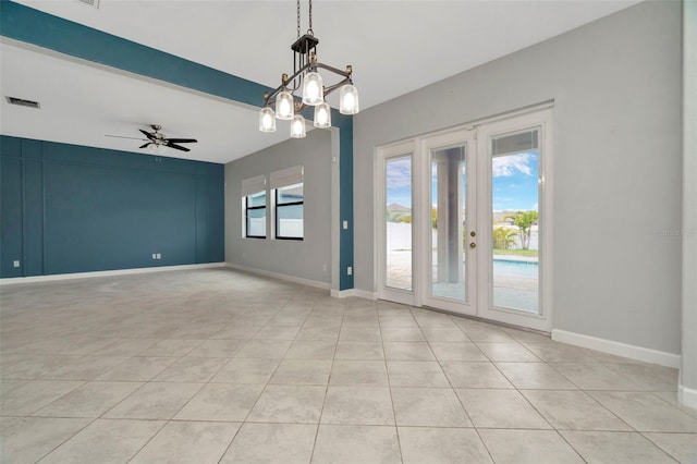 spare room featuring baseboards, visible vents, french doors, and ceiling fan with notable chandelier