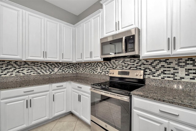 kitchen featuring white cabinetry, appliances with stainless steel finishes, tasteful backsplash, and light tile patterned flooring