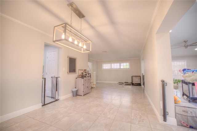 empty room with ceiling fan, ornamental molding, light tile patterned flooring, and baseboards