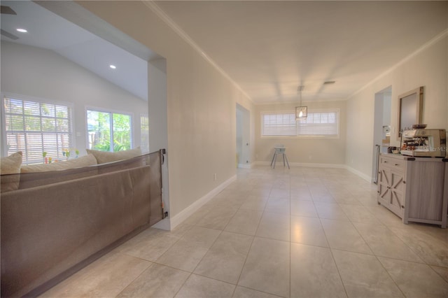 interior space with vaulted ceiling, crown molding, and baseboards