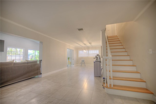 staircase with ornamental molding, tile patterned floors, visible vents, and baseboards