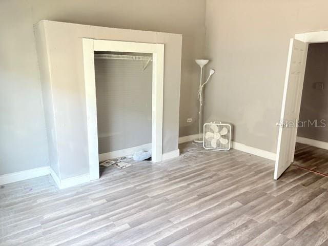 2410 Harper St, Tampa, FL 33605 - unfurnished bedroom featuring a closet, baseboards, and wood finished floors