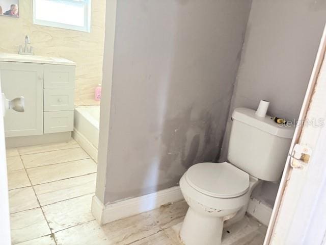 2410 Harper St, Tampa, FL 33605 - full bathroom featuring a bath, baseboards, toilet, and vanity