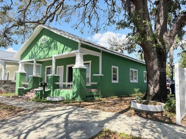 2410 Harper St, Tampa, FL 33605 - view of side of property featuring a porch and stucco siding