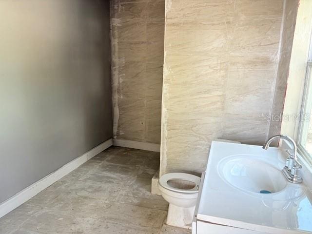 2410 Harper St, Tampa, FL 33605 - bathroom with baseboards, toilet, and vanity