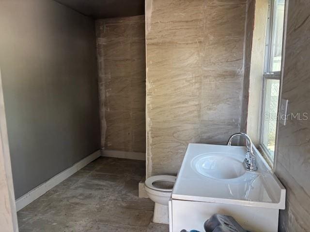 2410 Harper St, Tampa, FL 33605 - bathroom featuring baseboards, concrete floors, toilet, and vanity