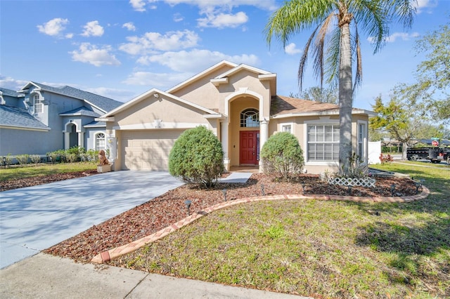 mediterranean / spanish-style house featuring a front yard, driveway, an attached garage, and stucco siding