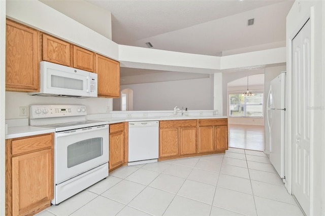 kitchen featuring arched walkways, light tile patterned flooring, white appliances, visible vents, and light countertops