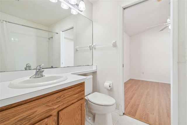 bathroom featuring toilet, wood finished floors, a ceiling fan, and vanity