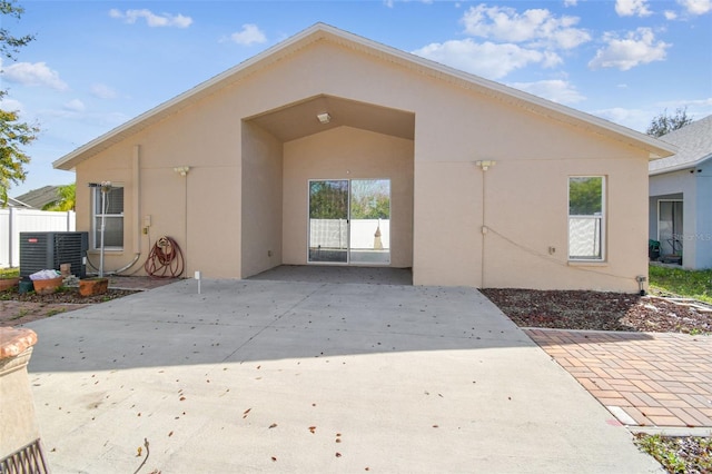 exterior space featuring central air condition unit, fence, a patio, and stucco siding