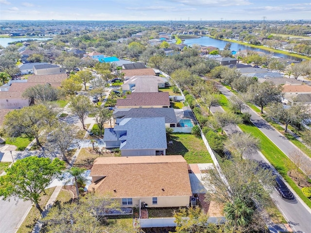 drone / aerial view with a water view and a residential view