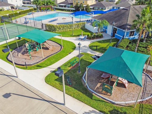 surrounding community with a residential view, playground community, and fence