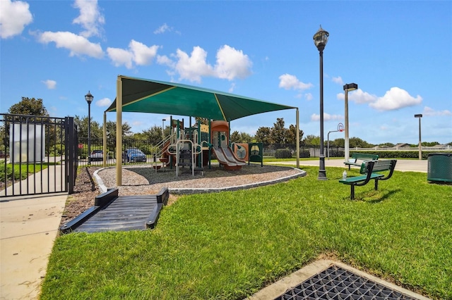 community playground with a yard and fence