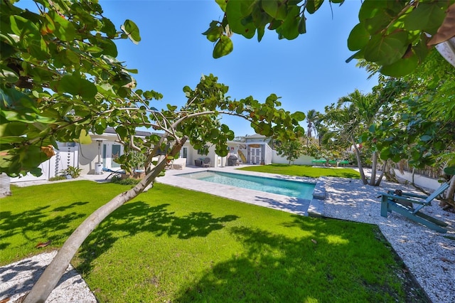 view of swimming pool featuring a patio area, a fenced in pool, fence private yard, and a yard