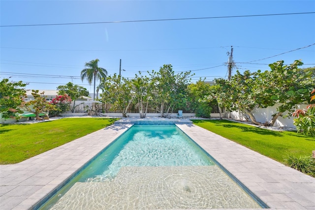 view of pool featuring a patio area, a lawn, a fenced backyard, and a fenced in pool