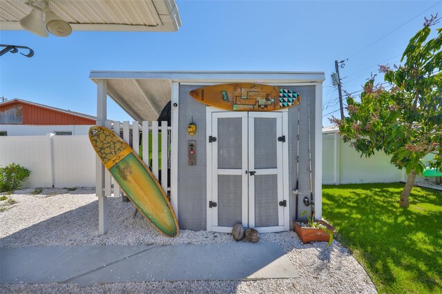 exterior space with an outdoor structure and fence