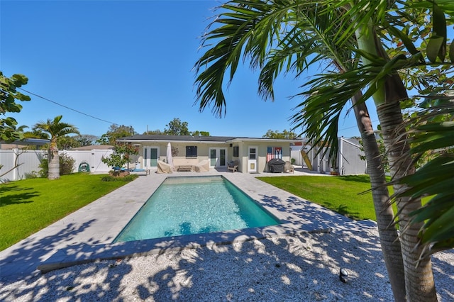 view of pool with a yard, a patio, a fenced in pool, and a fenced backyard