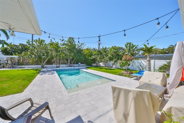 view of swimming pool with a fenced in pool, a patio area, a lawn, and a fenced backyard