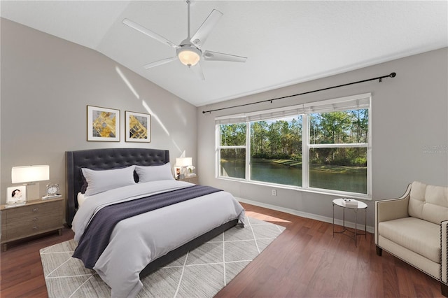 bedroom featuring baseboards, a ceiling fan, lofted ceiling, and wood finished floors