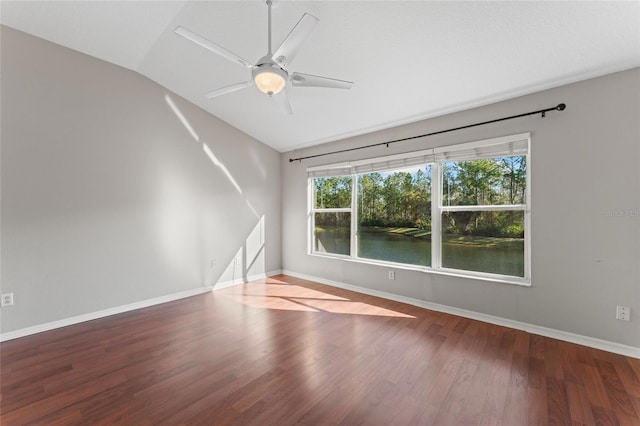 spare room with vaulted ceiling, ceiling fan, baseboards, and wood finished floors