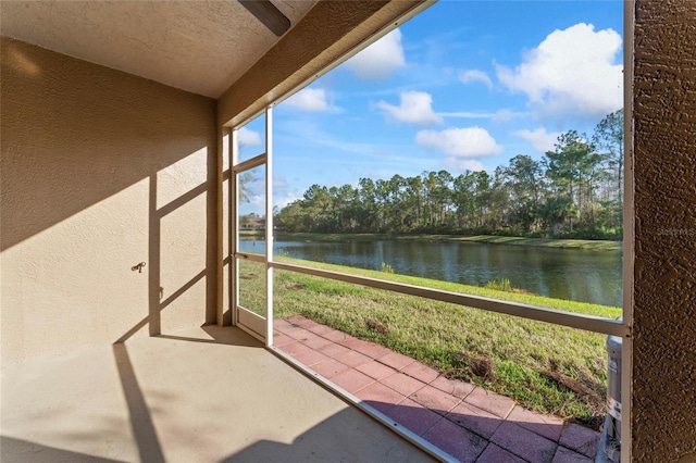 unfurnished sunroom with a water view