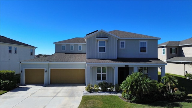 view of front of home with board and batten siding, concrete driveway, and an attached garage