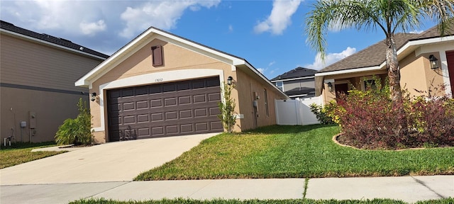 view of front of home featuring stucco siding, driveway, a front lawn, fence, and an attached garage