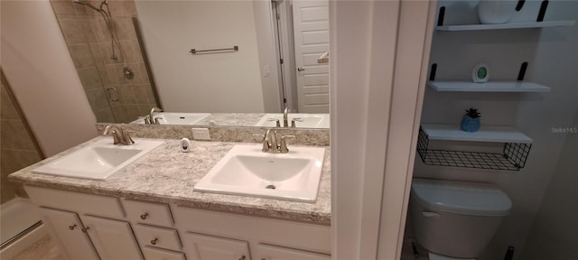 bathroom featuring a sink, toilet, and a shower stall