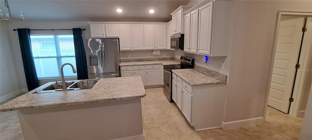 kitchen featuring an island with sink, recessed lighting, stainless steel appliances, white cabinetry, and a sink