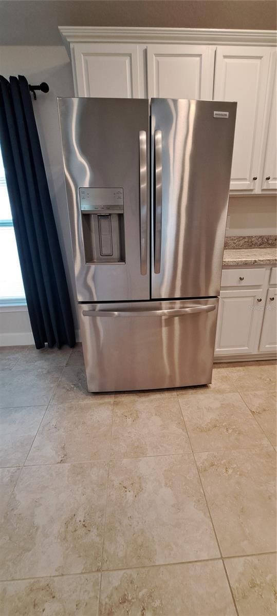 details featuring stainless steel fridge and white cabinets