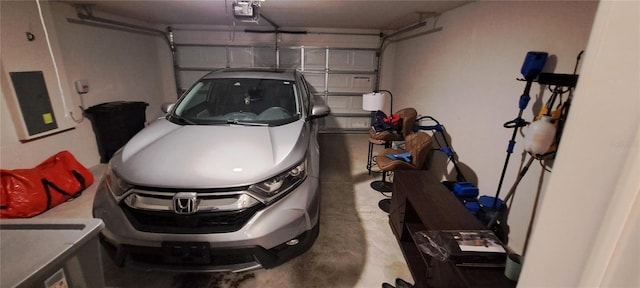 garage featuring electric panel and a garage door opener