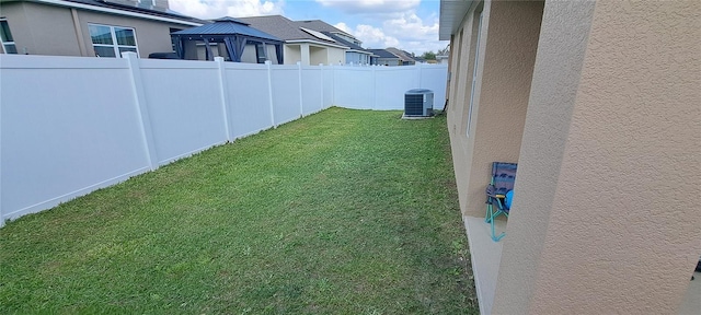 view of yard with cooling unit and a fenced backyard