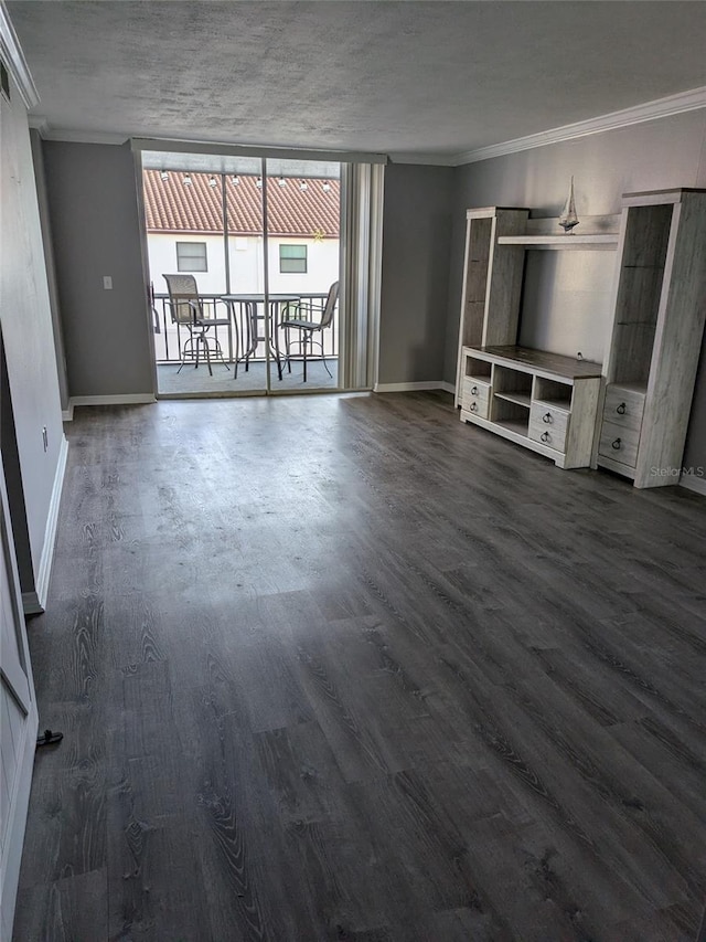 unfurnished living room featuring dark wood-style floors, baseboards, and ornamental molding