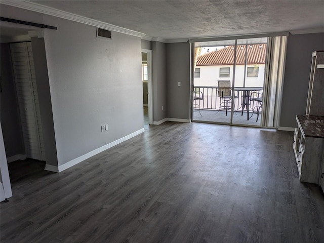 unfurnished living room featuring dark wood-style flooring, crown molding, visible vents, expansive windows, and baseboards