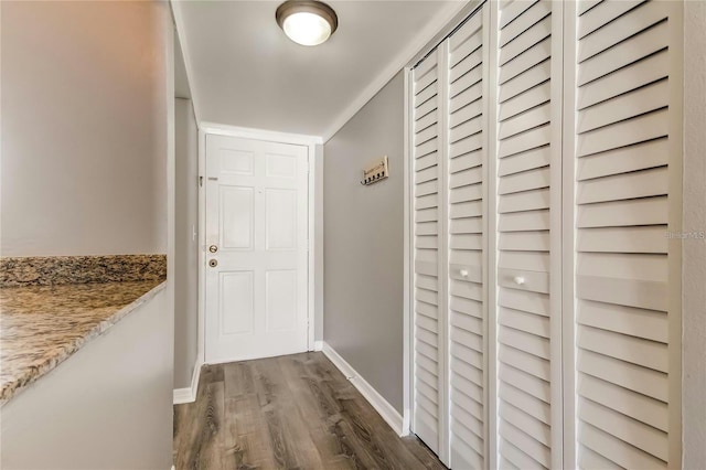 hall with baseboards and dark wood finished floors