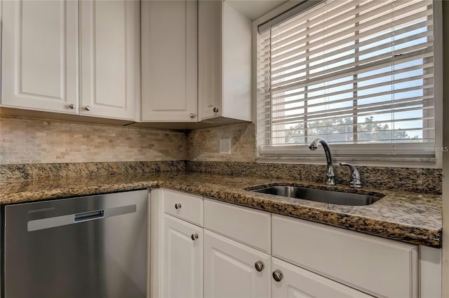 kitchen with tasteful backsplash, white cabinetry, dishwasher, and a sink