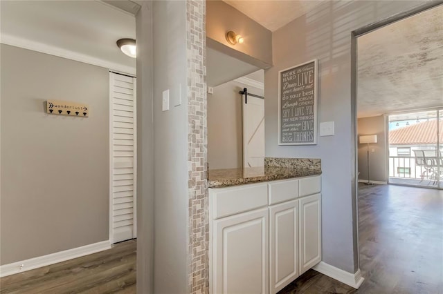 bathroom with vanity, baseboards, and wood finished floors