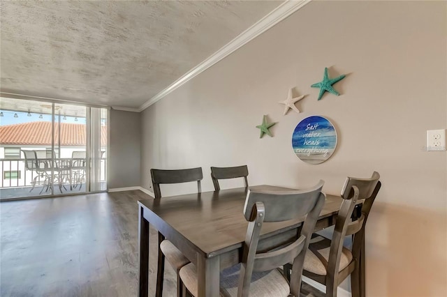 dining area with ornamental molding, wood finished floors, and baseboards